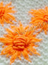 Вышитые хризантемы на вязаном полотне